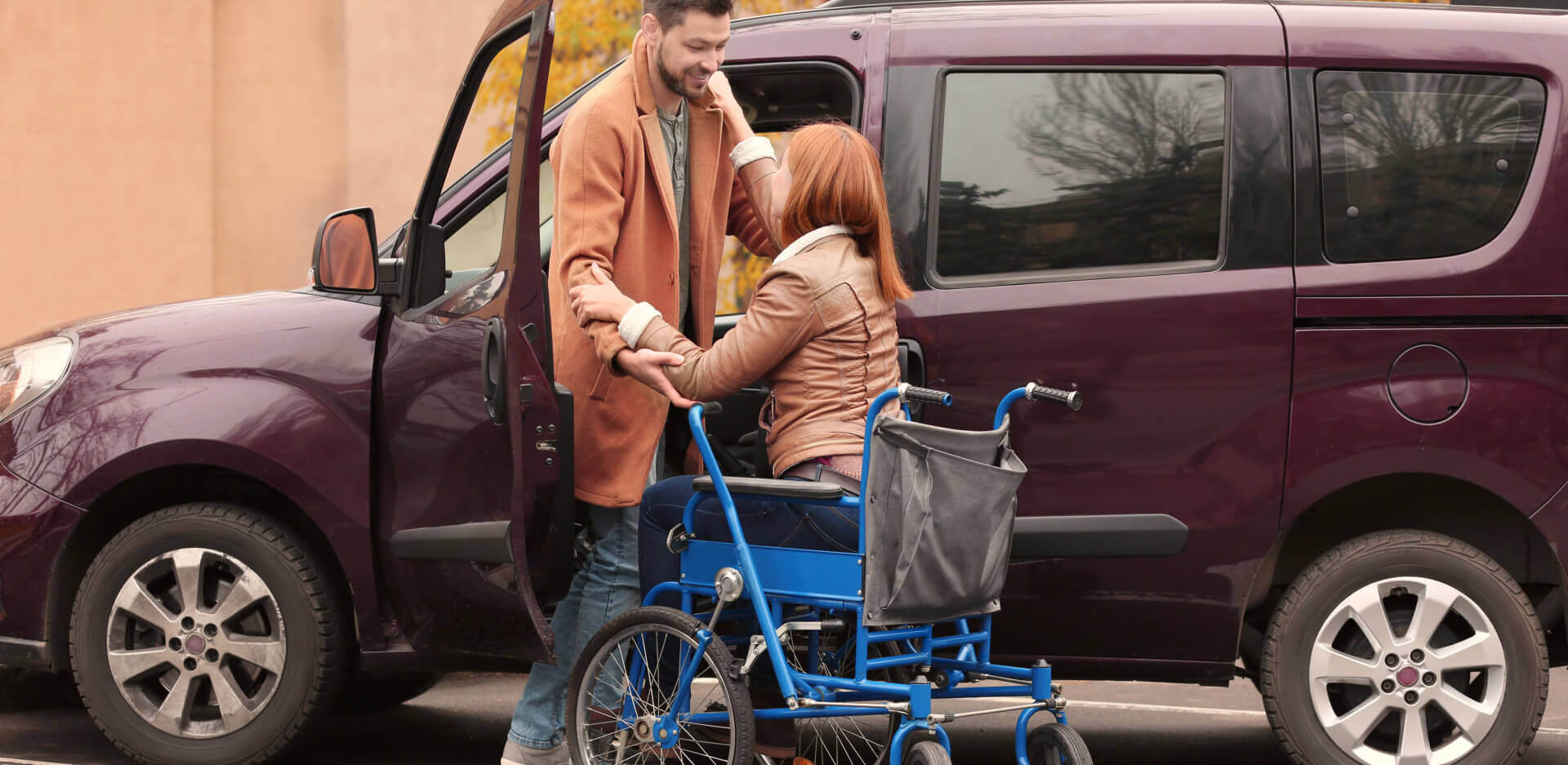 male caregiver assisting the patient to the van