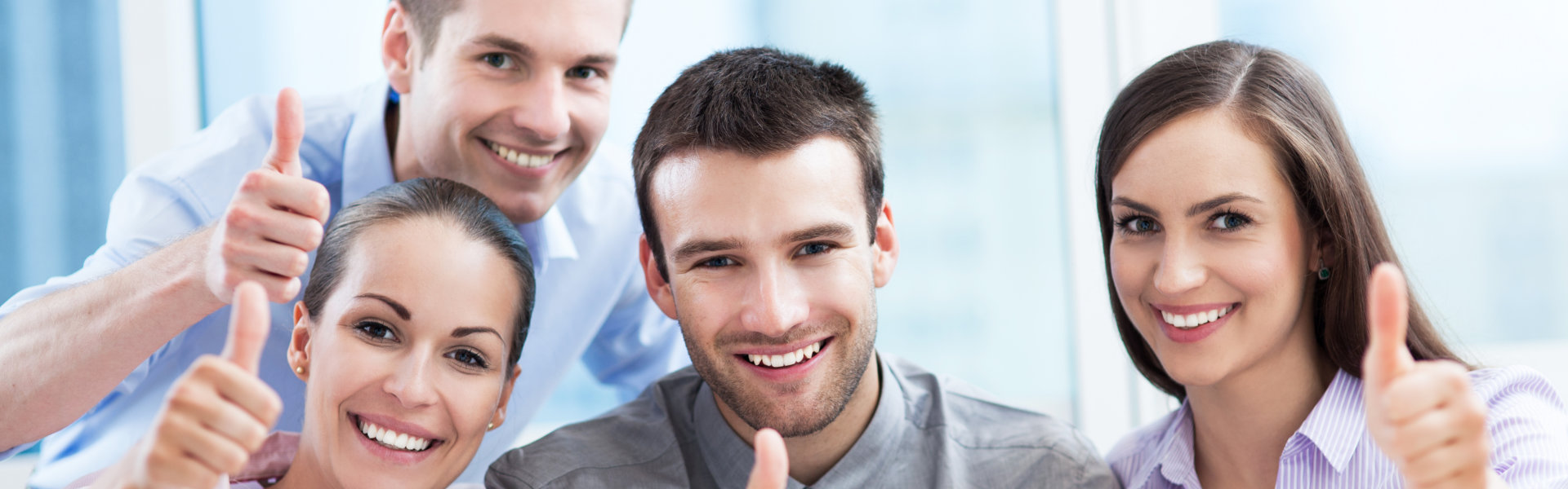 smiling people raising a thumb